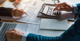 A person clicking on the screen ensures financial clarity and efficiency by using tax software with a positive mindset
